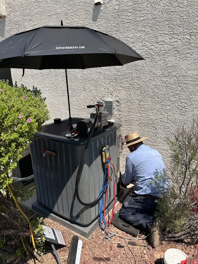 HVAC technician performing outdoor AC maintenance in El Mirage